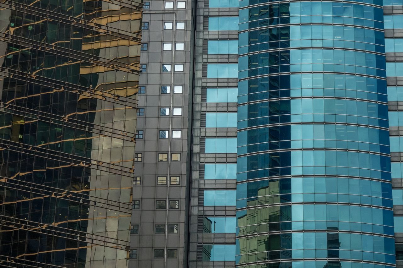 An urban cityscape of skyscraper facades with glass reflections showcasing modern architecture.